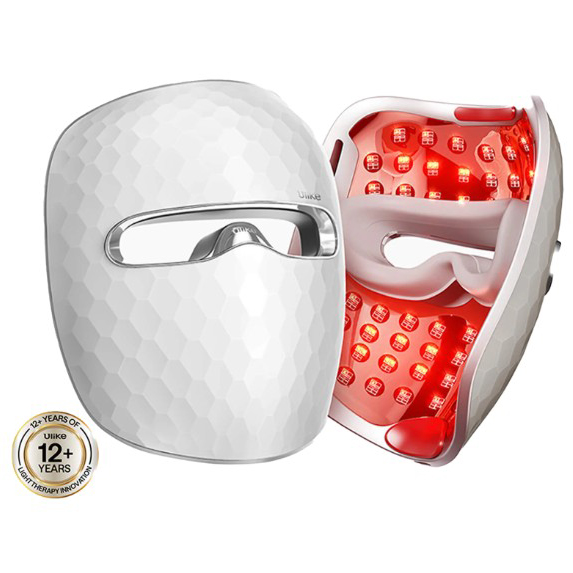 A white LED light therapy mask with a geometric pattern on the outside and red lights inside, designed for skincare treatment.