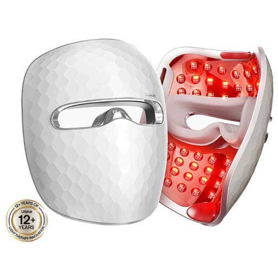 A white LED light therapy mask with a geometric pattern on the outside and red lights inside, designed for skincare treatment.
