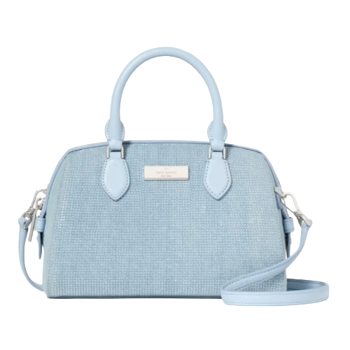 A light blue textured handbag with dual handles and a detachable shoulder strap, featuring a metallic logo plate on the front.