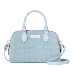 A light blue textured handbag with dual handles and a detachable shoulder strap, featuring a metallic logo plate on the front.