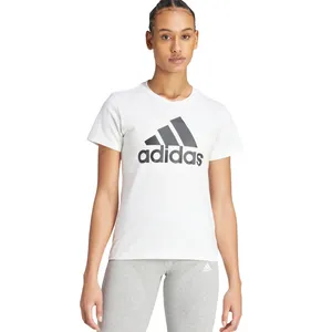 A person is wearing a white Adidas t-shirt with the logo on the front and gray Adidas leggings, showcasing casual sportswear.