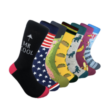 A set of four pairs of socks, each with unique designs: American flag, yellow bananas, blue with pink flamingos, and grey with flying ducks.