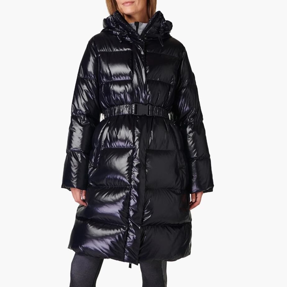 A glossy black parka with a hood, a belted waist, and a long, puffy silhouette that extends to knee-length.