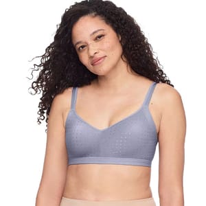 A woman is wearing a gray, lightly textured bralette with adjustable straps, paired with beige bottoms.