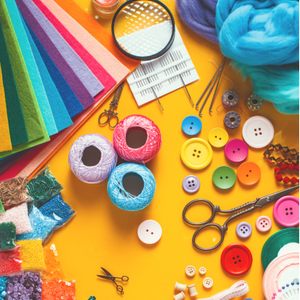 Colorful craft supplies including felt sheets, yarn, buttons, beads, embroidery threads, scissors, and crochet hooks on a yellow background.