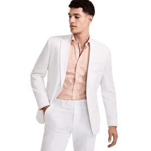 A man is wearing a white suit paired with a light orange, patterned dress shirt.