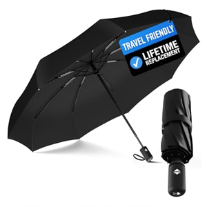 A black travel-friendly umbrella with a lifetime replacement guarantee, shown open and folded. Various color options are displayed: teal, white, yellow, pink, red, green, navy, and blue.