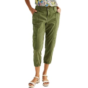 Green cargo capri pants with elastic cuffs, button and zipper closure, and side pockets. Paired with a floral top and white open-toe block sandals.