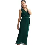 A woman wearing a sleeveless, dark green pleated midi dress with a wrap design and a matching tie belt.
