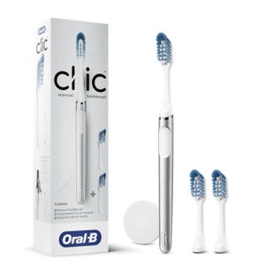 Oral-B Clic Toothbrush Kit includes a manual toothbrush with a white and silver handle, two blue replacement brush heads, and a magnetic brush holder.