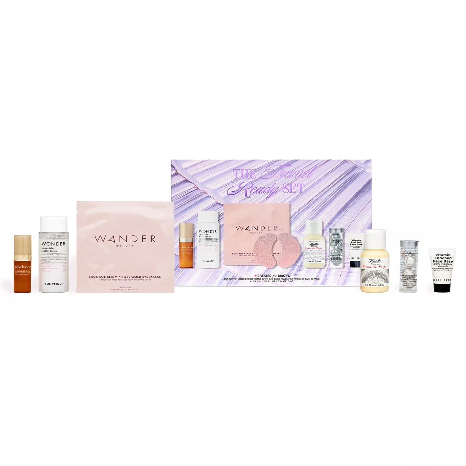A Macy's travel-ready set featuring skincare items including Wander Beauty eye masks, Tonymoly products, and Kiehl's lotion, among others, in a purple box marked \“The Travel Ready Set.\“