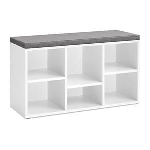A white storage bench with a gray cushioned top features six open cubby compartments, suitable for organizing and seating.