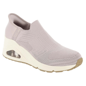 A slip-on shoe with a knitted upper, featuring a wedge heel and an air-cushioned sole. The shoe is in a light beige color, and it includes the brand name \“Skechers Slip-ins\“ on the side.