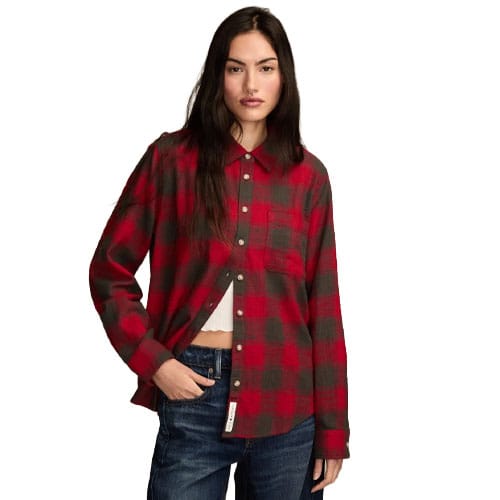 A person wearing a red and gray checkered button-up shirt with long sleeves, accompanied by blue jeans.