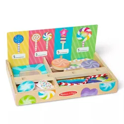 A wooden toy set featuring colorful pretend lollipops and sweets, displayed in a box with compartments and a price label board.