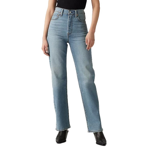 A person wearing high-waisted, straight-leg blue jeans paired with a black sleeveless top and black boots.