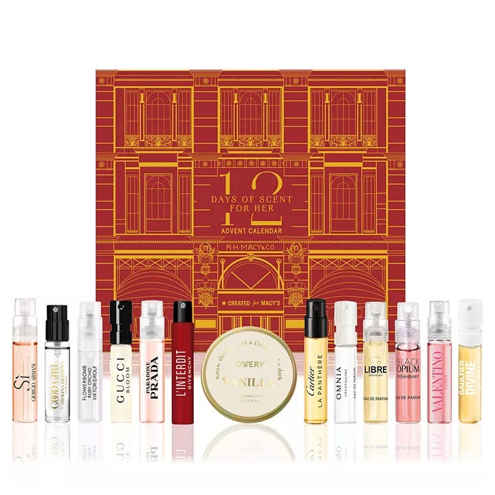12 Days of Scent for Her Advent Calendar by Macy's featuring various perfume samples from brands like Giorgio Armani, Gucci, Prada, Givenchy, Cartier, Bulgari, Yves Saint Laurent, Valentino, and Dior. Includes a vanilla-scented candle.