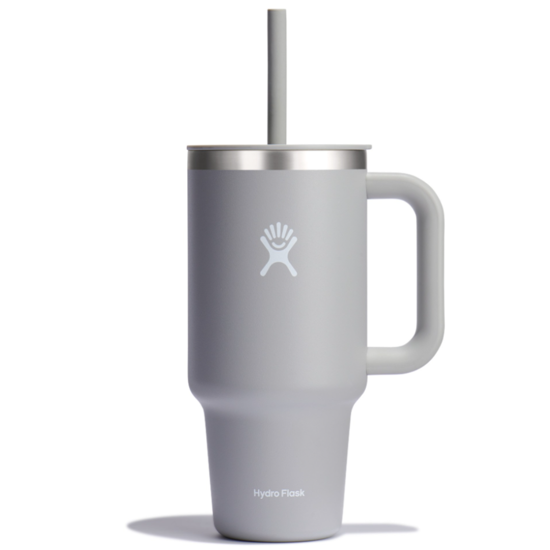 Gray Hydro Flask tumbler with a handle and a lid featuring a straw, displaying the Hydro Flask logo.
