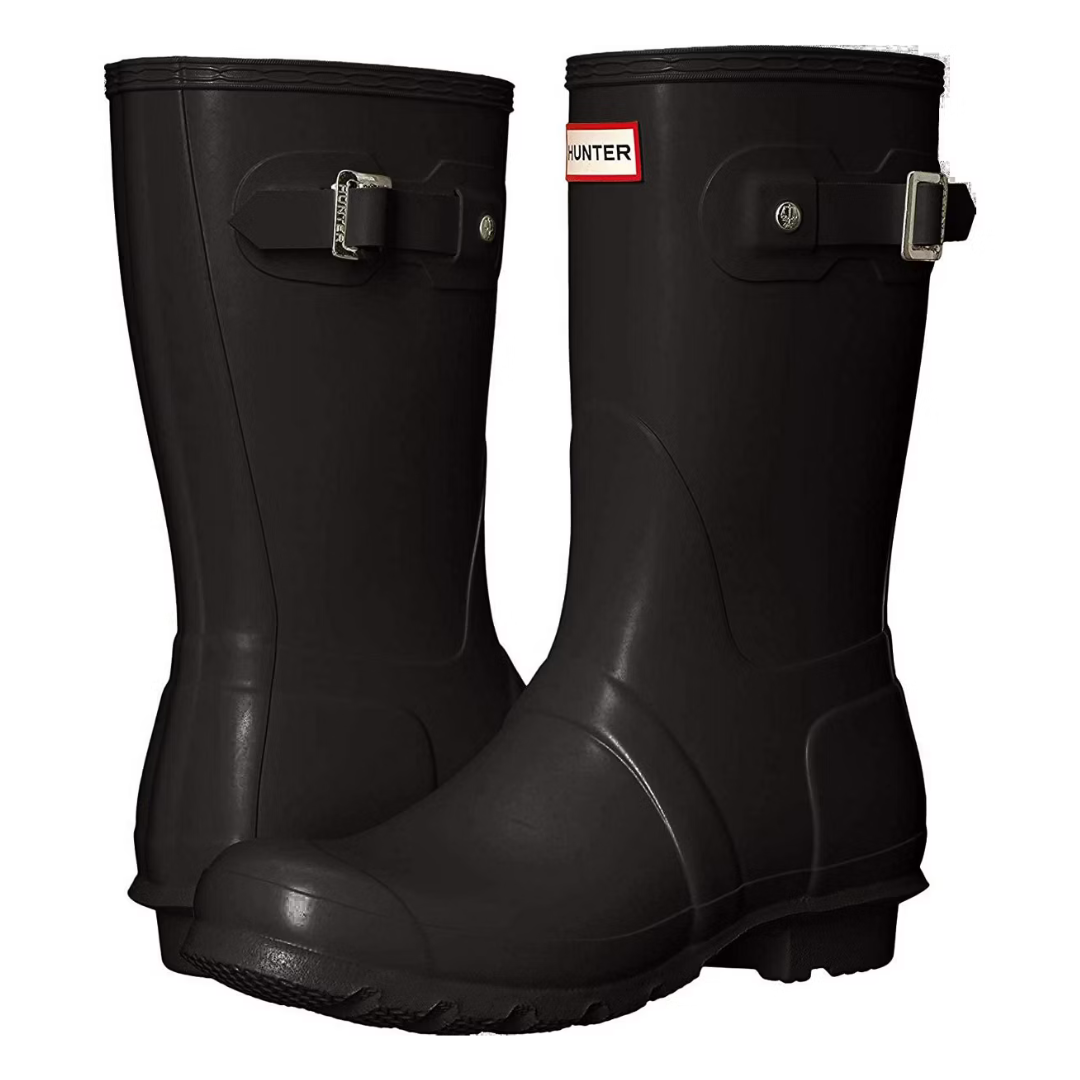 Black rain boots with a side buckle and brand label on the front top, featuring a rugged sole for wet weather.