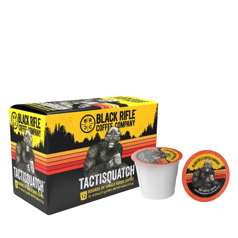 Black Rifle Coffee Company's 12-count Tactisquatch Coffee Rounds feature artwork of a sasquatch with tactical gear and are designed for single-serve use. The box is yellow with a forest background and a multi-colored stripe.