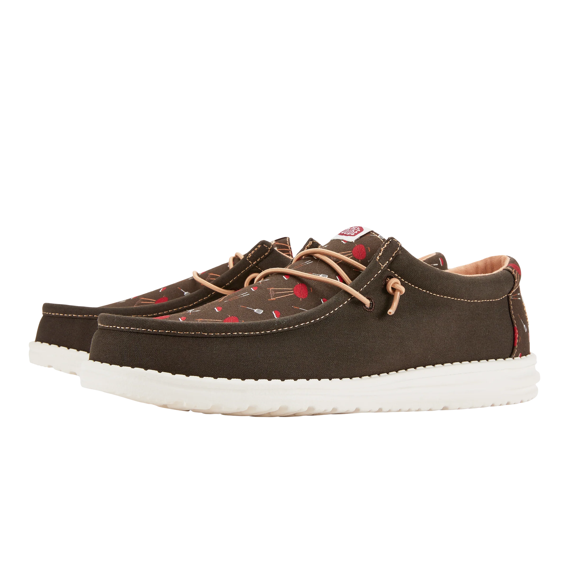 A pair of dark brown boat shoes with white soles and red heart patterns.