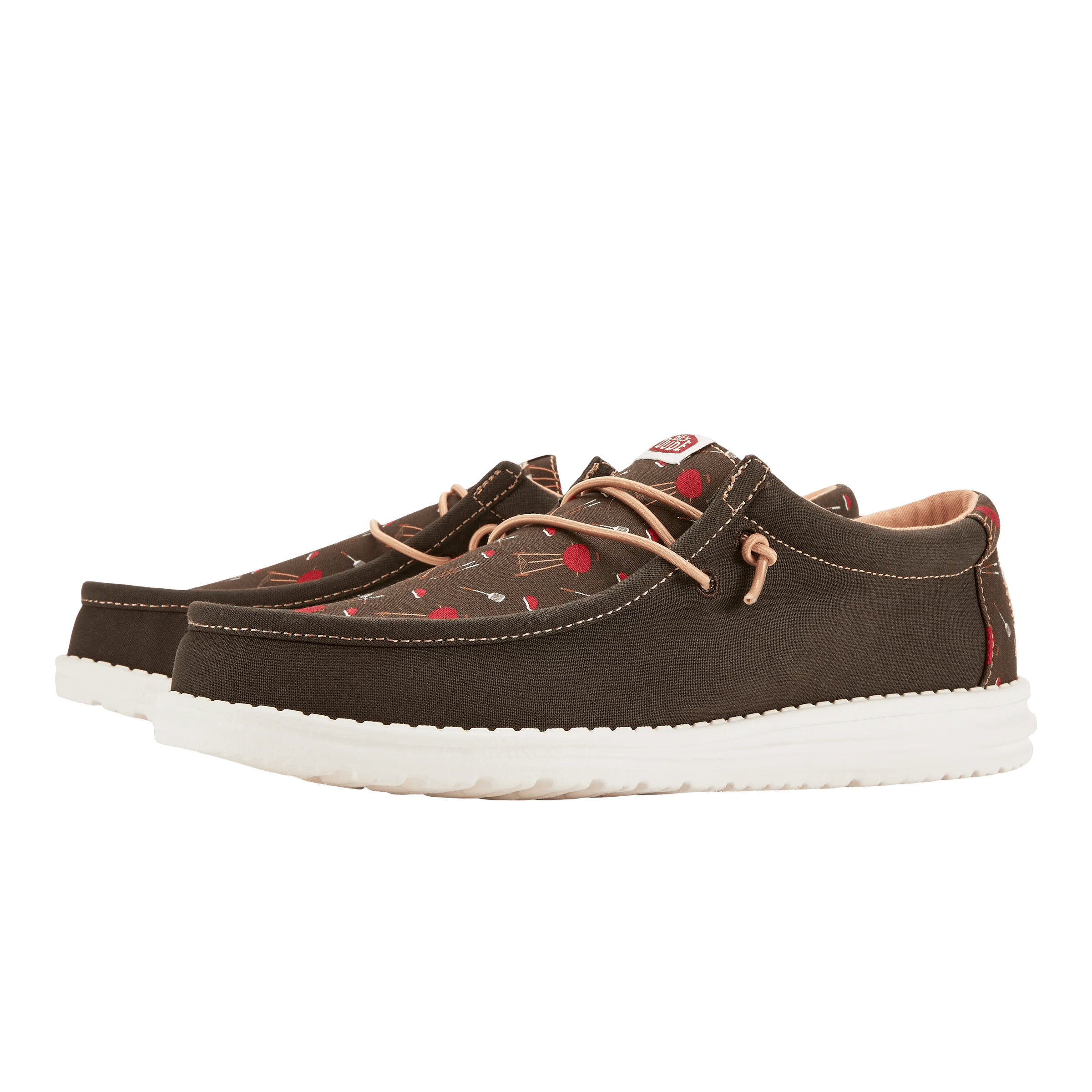 A pair of dark brown boat shoes with white soles and red heart patterns.