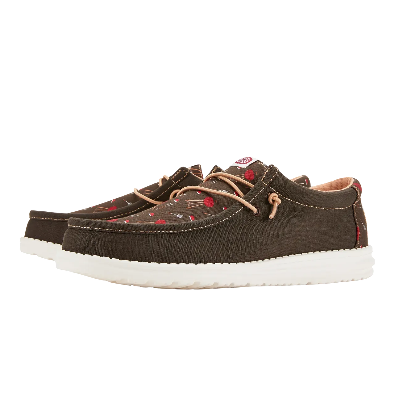 A pair of dark brown boat shoes with white soles and red heart patterns.