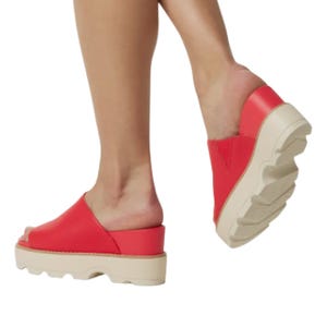 Red open-toe platform sandals with thick white soles, featuring a slip-on design for casual wear.