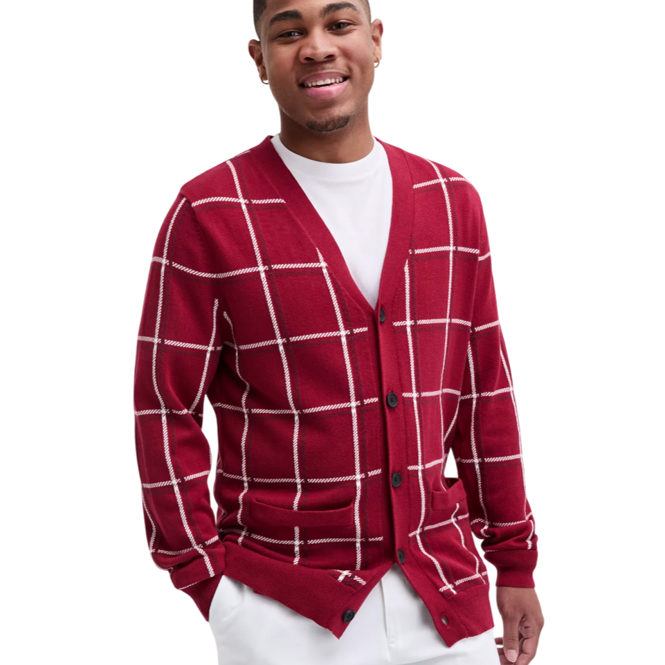 A person is wearing a red cardigan with a white checkered pattern, over a white T-shirt.
