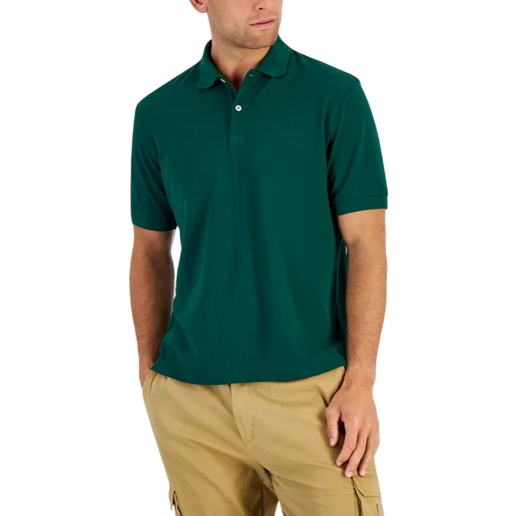 A man is wearing a short-sleeve, dark green polo shirt paired with beige cargo shorts.