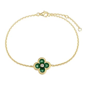A gold chain bracelet featuring a green clover-shaped charm with a central diamond and a lobster clasp closure.