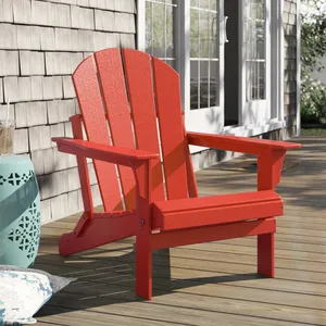 A red Adirondack chair on a wooden deck.