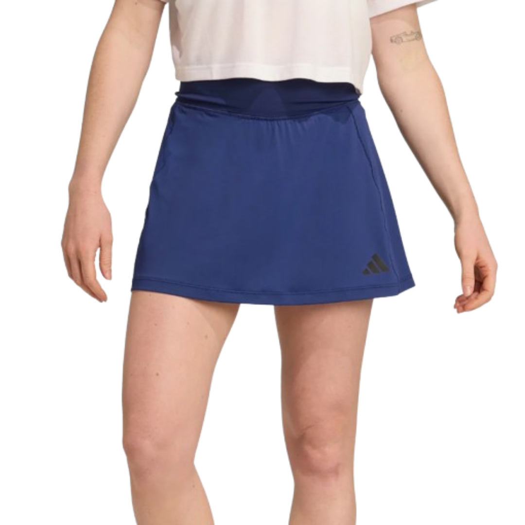 Blue athletic skirt with black Adidas logo, worn with a white top.