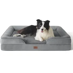 A black and white dog is lying on a gray rectangular dog bed with raised edges.