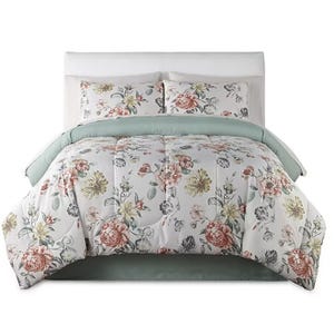 A floral-patterned bedding set featuring a comforter and matching pillow shams, accented with soft green.