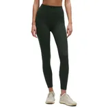 High-waisted, dark green leggings paired with beige sneakers.