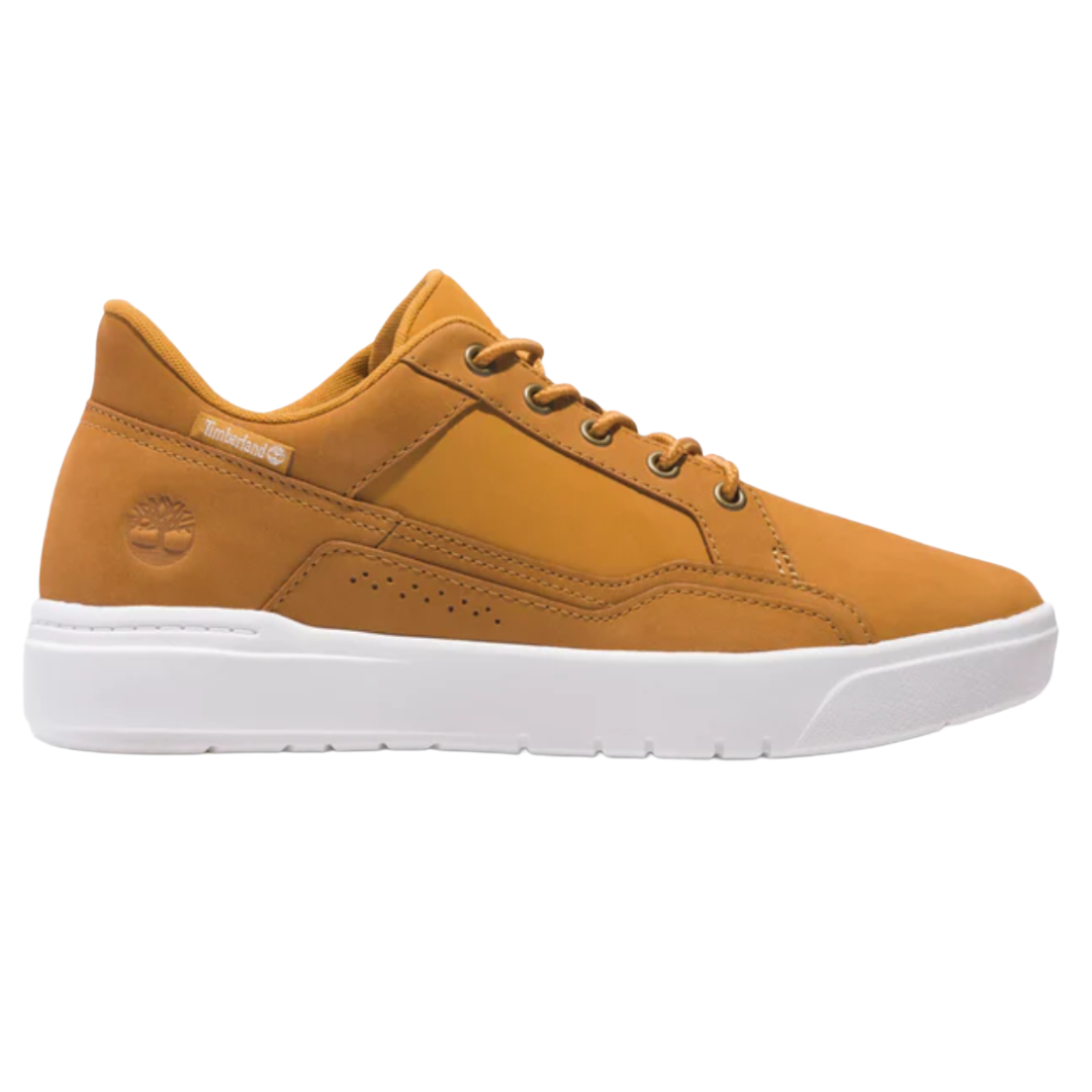 A tan nubuck sneaker with a white sole, featuring the Timberland logo on the side and a lace-up design.