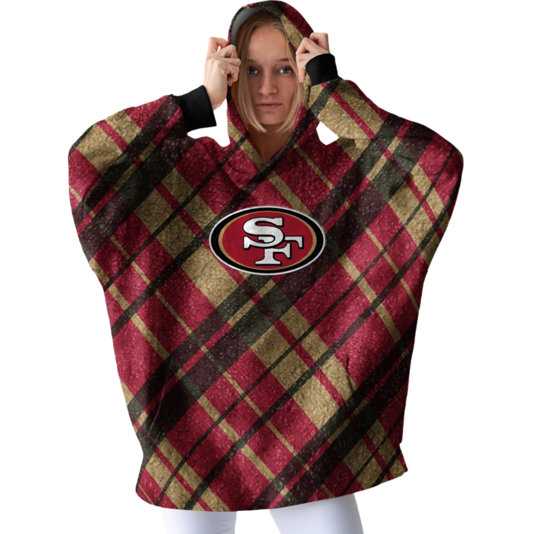 A person wears a plaid hooded garment featuring the San Francisco 49ers logo in red, gold, and black.
