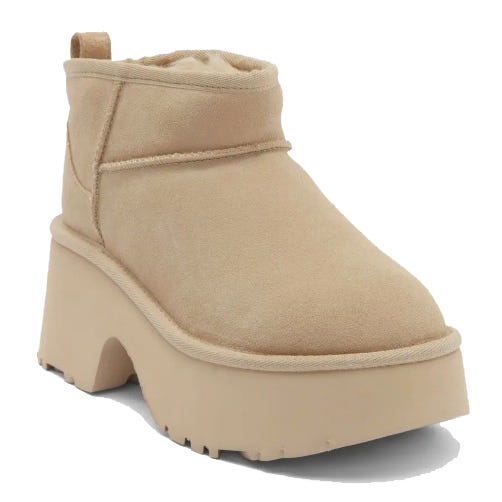 Beige platform ankle boot with a thick sole and rounded toe.