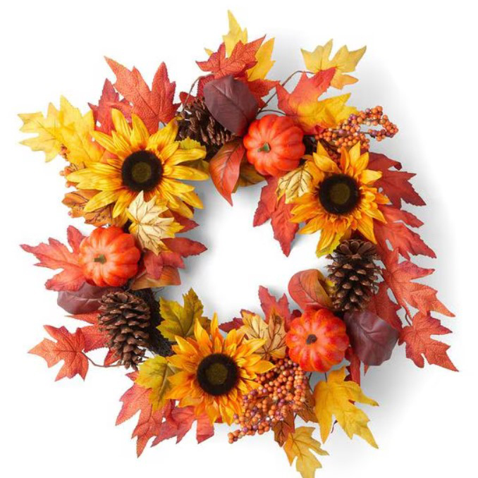 A decorative wreath featuring artificial fall foliage, such as red and yellow leaves, sunflowers, small pumpkins, and pine cones. The wreath measures 23 inches across.