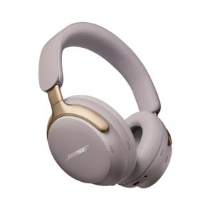 Over-ear headphones with noise-canceling feature, gold and light grey color scheme, and Bose branding on the side.