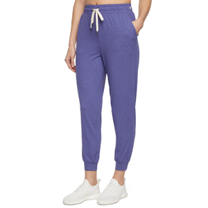 A person is wearing purple jogger pants with a drawstring waist and white sneakers.