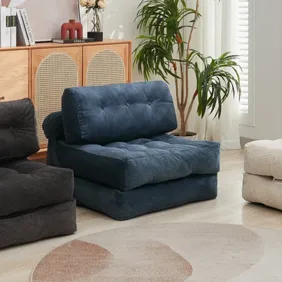 Three cushioned folding chairs in black, navy, and beige are shown in a living room setting with a wooden cabinet, plant, and abstract rug, highlighting their availability in multiple colors.