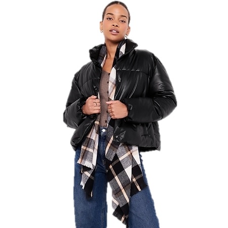 A woman is wearing a black puffer jacket, a checkered scarf, a denim button-up shirt, and blue jeans.