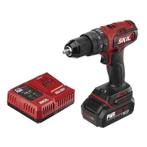 The SKIL PWRCore 20V 1/2\“ Hammer Drill is a cordless power tool featuring a lithium battery and a charger. The drill has a red and black design with variable speed settings, suitable for drilling and hammering tasks.