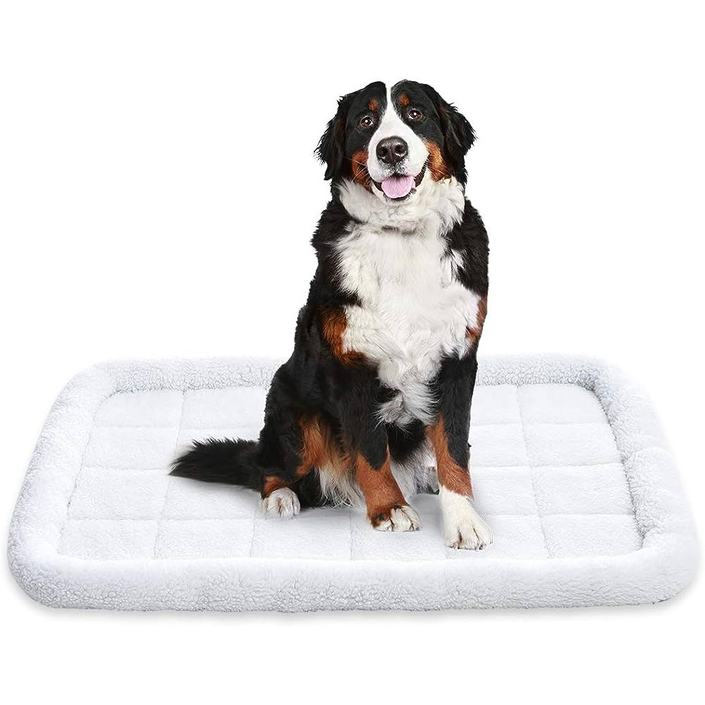 A large, rectangular pet bed with a soft, white fleece surface and cushioned edges, suitable for dogs.