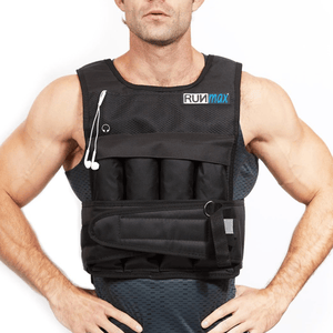 A person is wearing a black weighted vest from RUNmax, which has pockets and an attached strap. Earbuds are hanging from the front.