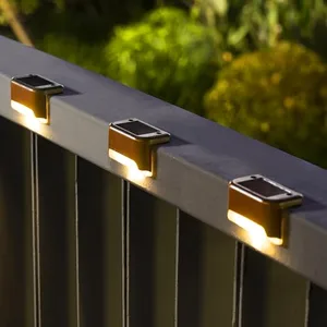 Solar-powered LED fence lights illuminate a railing, providing outdoor lighting.