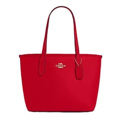 Red leather Coach Outlet tote with gold logo and detailing, two handles, and a hanging tag.