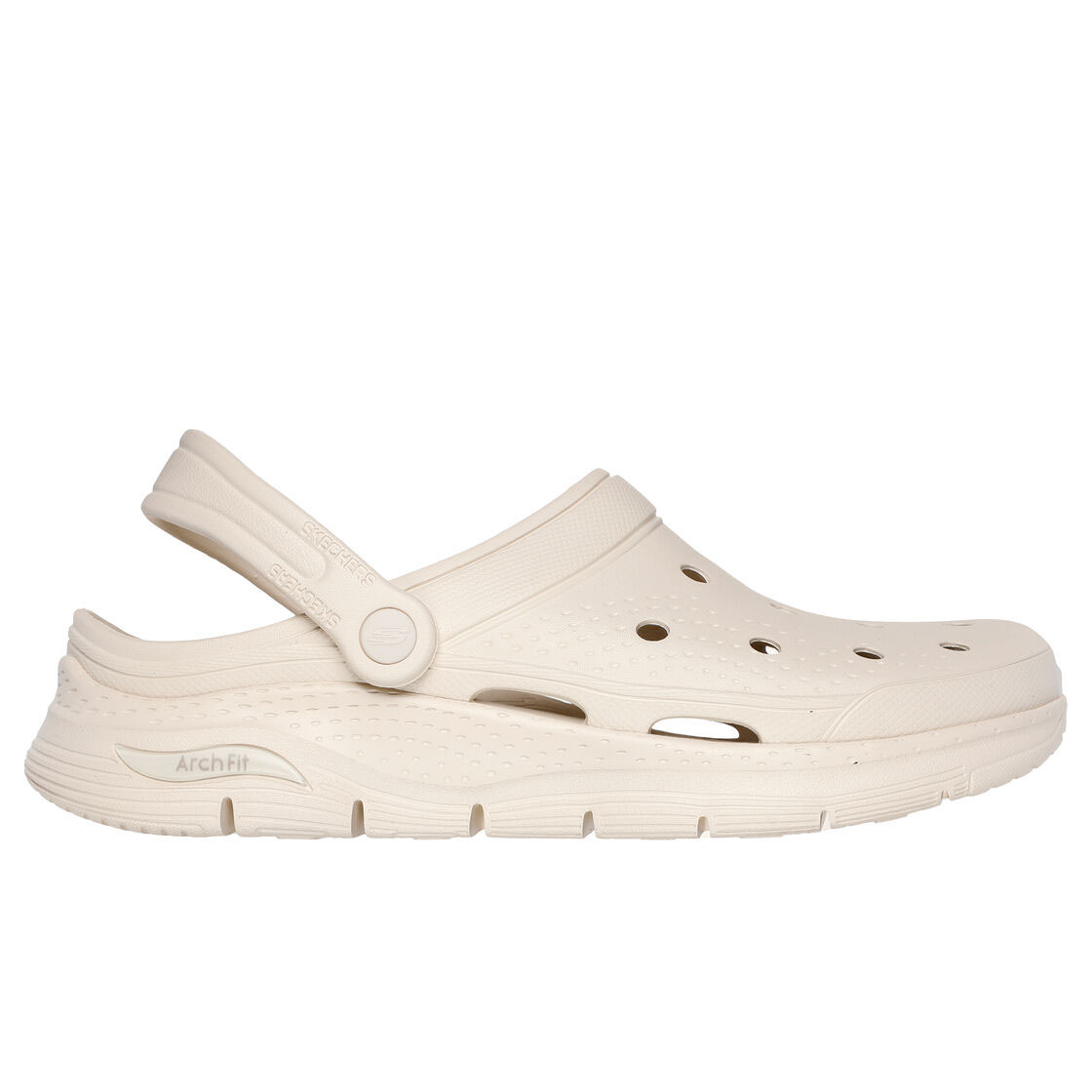 Skechers Foamies Arch Fit Clogs are beige-colored, slip-on clogs featuring perforated holes for breathability, a back strap for secure fit, and an Arch Fit design for comfort.